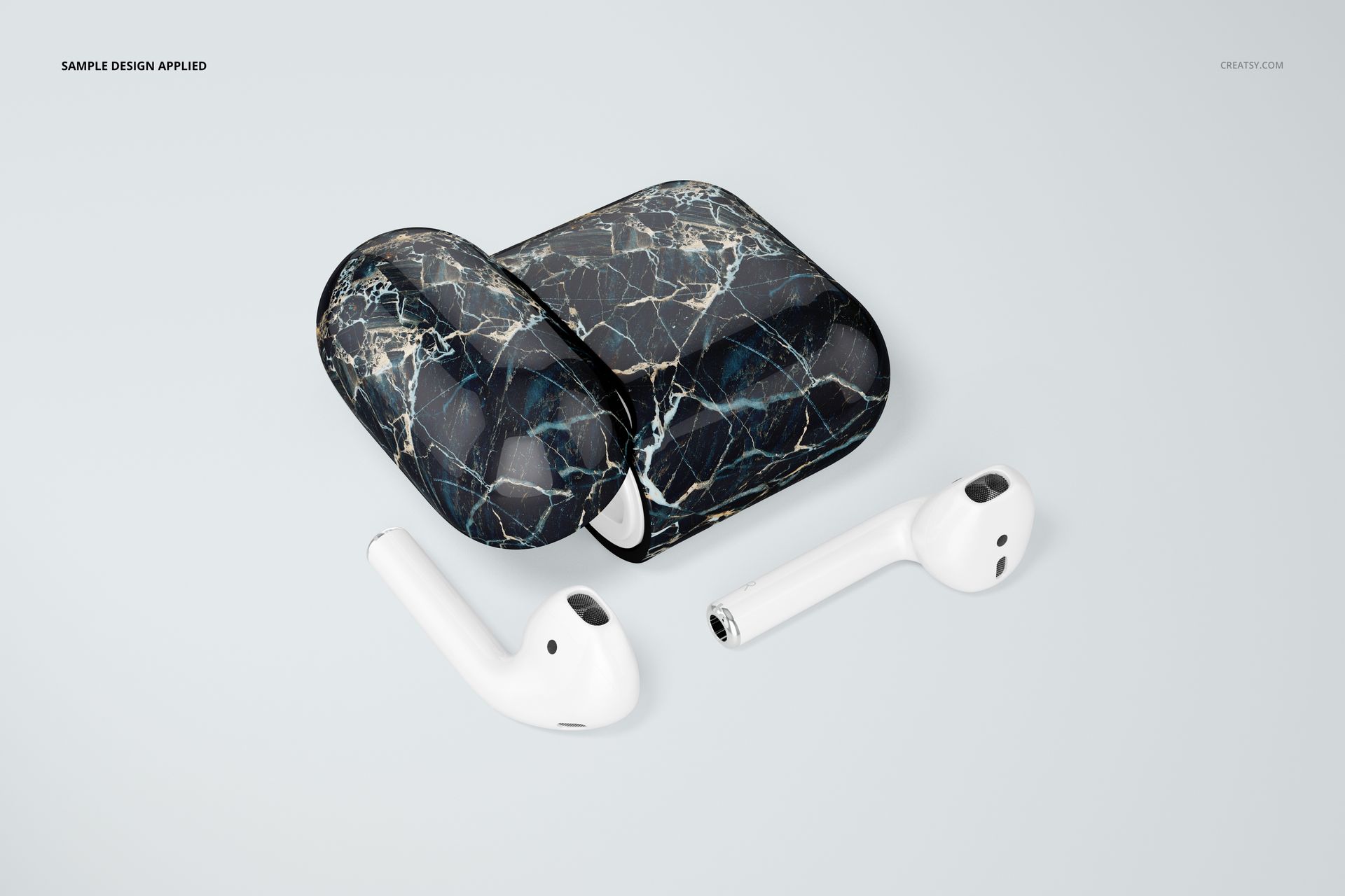 Front view of a black marble patterned AirPods case mockup set with two white earbuds placed nearby on a white surface.