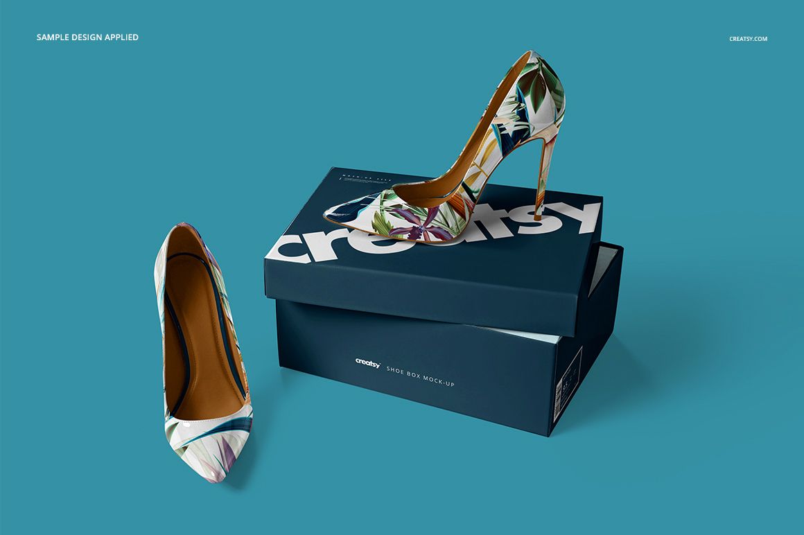PSD mockup featuring stylish high heels with multicolor leaf design beside a branded dark blue shoebox.