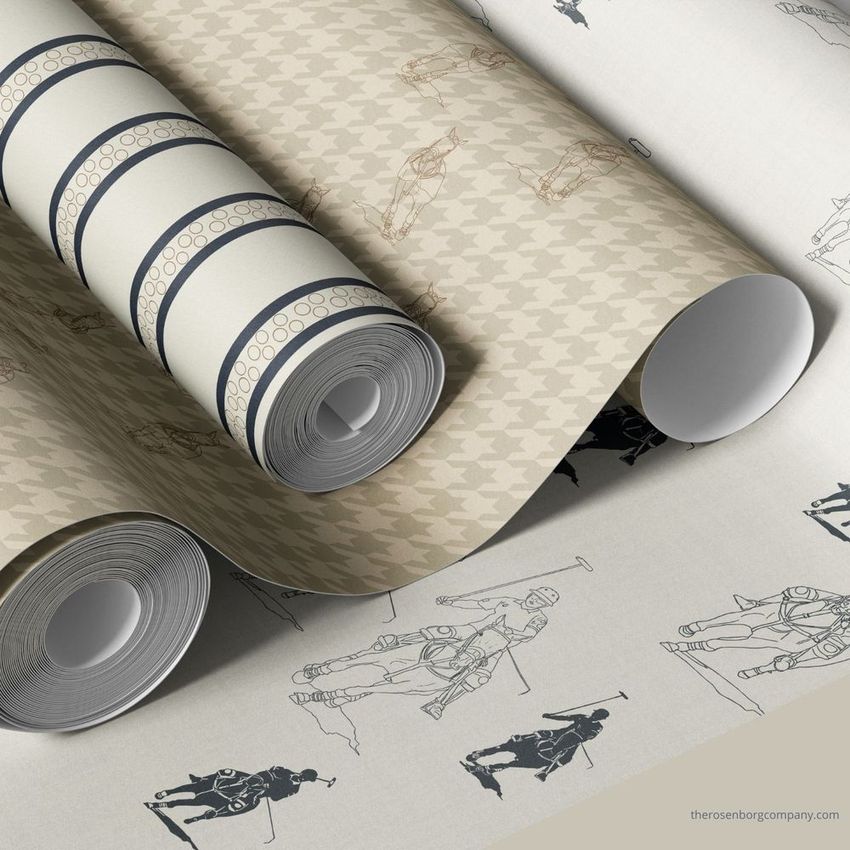 Paper wallpaper mockup showing three rolled sheets with polo player illustrations and geometric patterns in beige and navy tones.