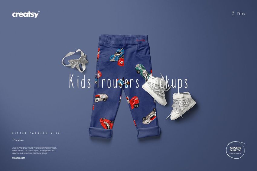 Front view of kids trousers mockup with blue fabric and colorful car pattern, surrounded by white shoes and gray accessories.