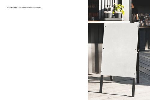 Blank A-frame advertising stand mockup with white panel and black legs, positioned outdoors near a cafe setting.