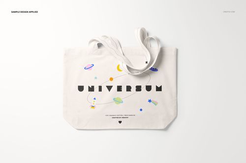 Front view of a weekender tote bag mockup with white fabric, playful space-themed graphics, and long handles.