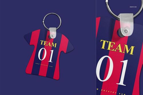 Close-up of soccer jersey keychain mockup featuring bold red and navy stripes and a metal ring attachment.