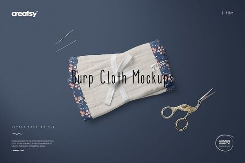 Burp cloth mockup set featuring a cream quilted fabric bordered by navy floral print, displayed with sewing tools on a blue background.