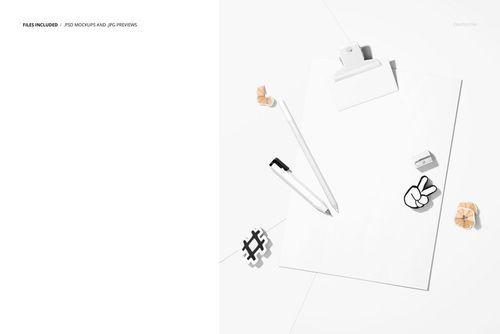 Top view of a notepad poster mockup on a white desk with pencil, eraser, paper clips, and cartoon stickers.