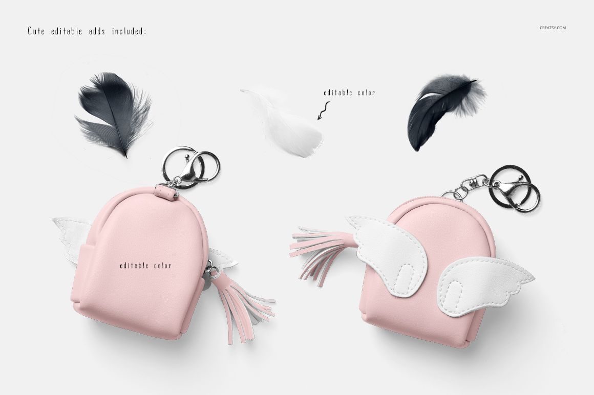 Front view of two pastel pink baby harem shorts mockups with wing and tassel keychain props on a white background.