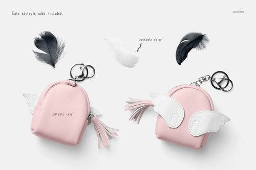 Front view of two pastel pink baby harem shorts mockups with wing and tassel keychain props on a white background.
