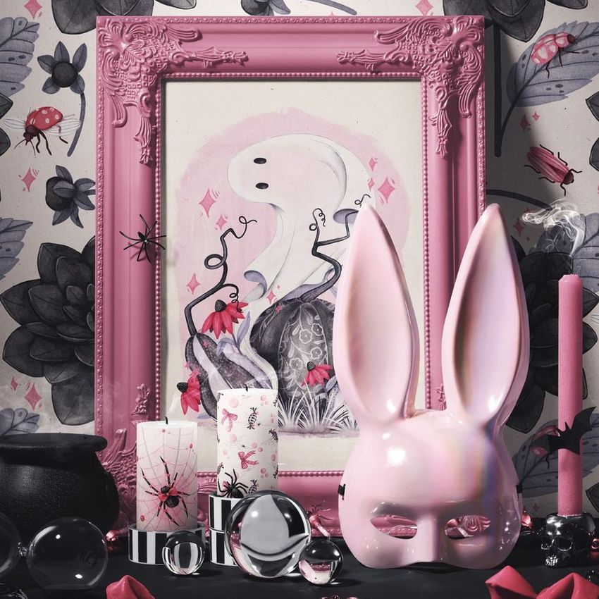 Halloween art print mockup featuring a pink ornate picture frame with a ghost illustration, surrounded by themed props and decor.