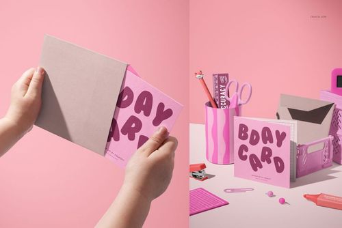 Greeting card PSD mockup featuring a pink card with graphic text next to stationery items and a pink storage box.