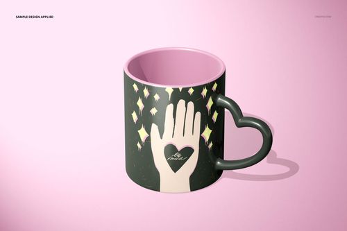 Front view of a heart-shaped handle mug mockup with a pink inside and hand design surrounded by yellow stars.