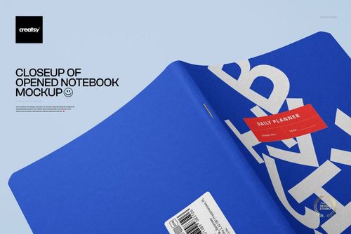 Opened notebook mockup featuring a blue cover with large white lettering and a red rectangular label on a light background.
