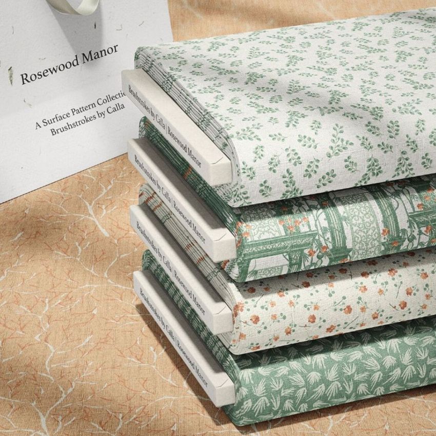 Fabric bolts mockup featuring five stacked bolts with botanical and geometric patterns in green and beige tones on a textured surface.