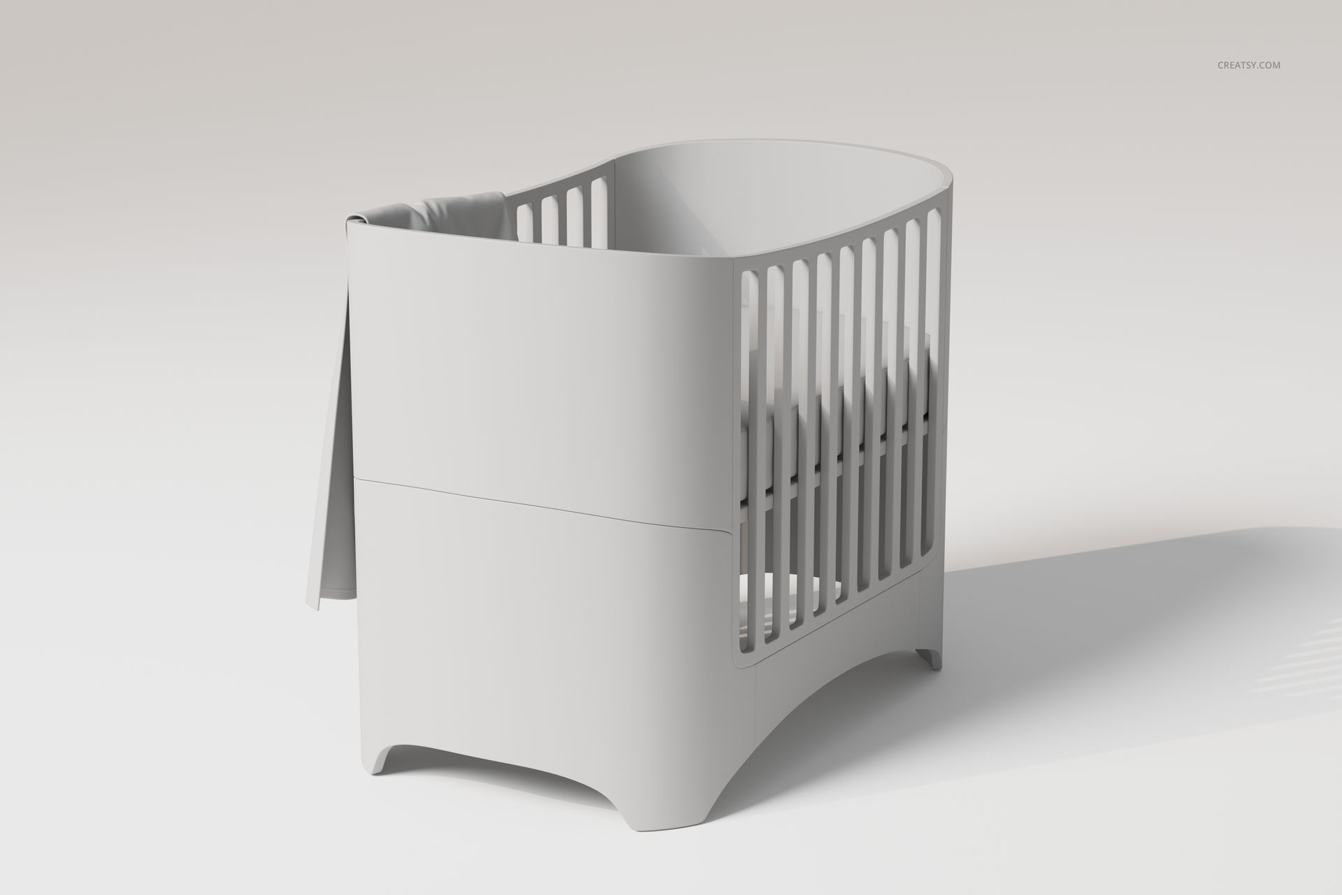 Modern crib with curved edges and vertical slats, featuring a large baby blanket draped over the side, front view.