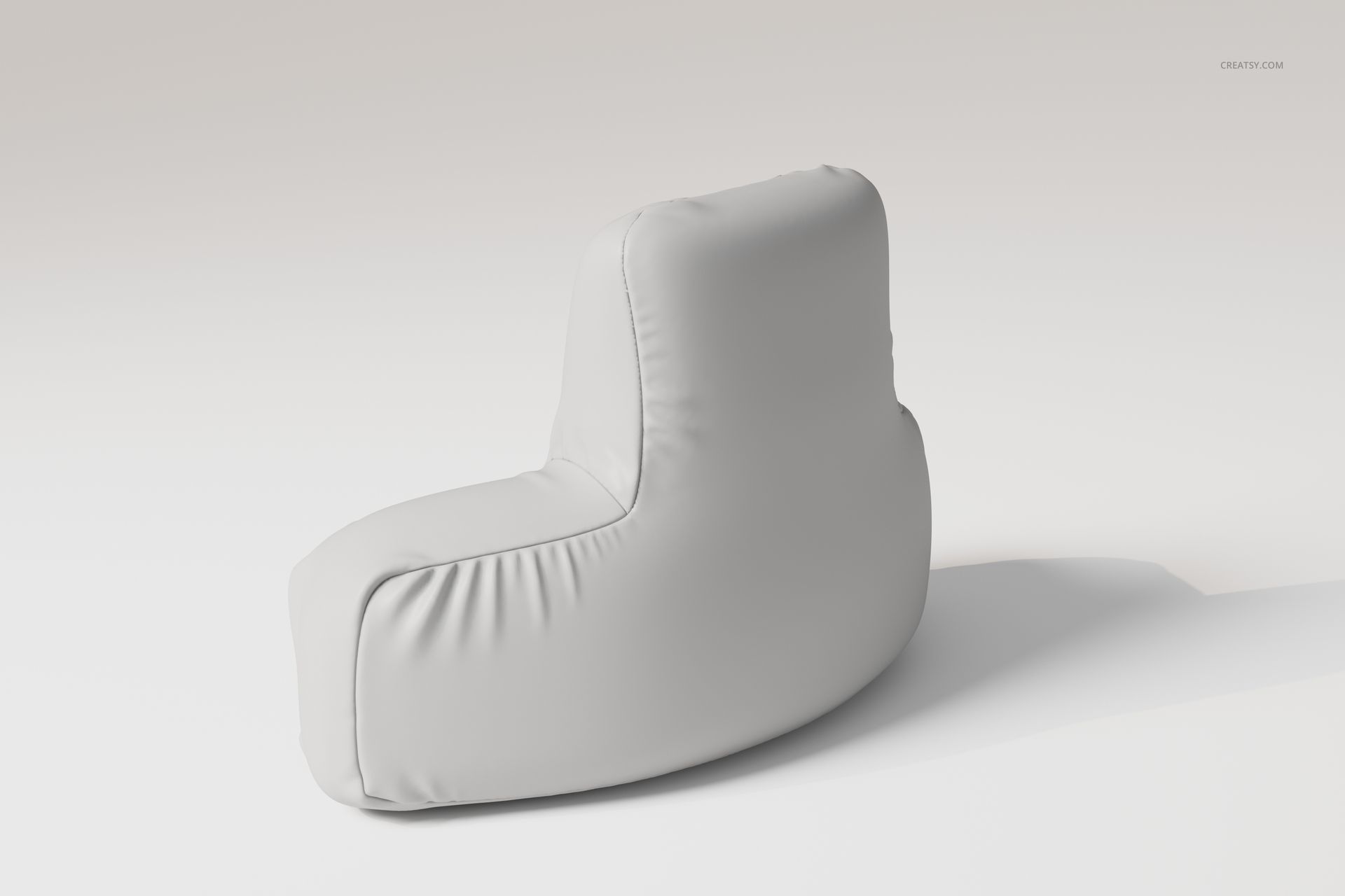 Curved reading pillow in solid light gray fabric, shown from a rear side angle on a plain neutral background.