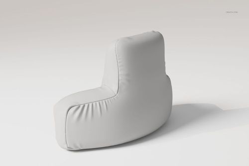 Curved reading pillow in solid light gray fabric, shown from a rear side angle on a plain neutral background.