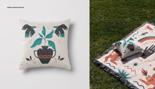 PSD mockup of a square woven pillow with earthy illustration, paired with a decorative blanket in an outdoor setting.