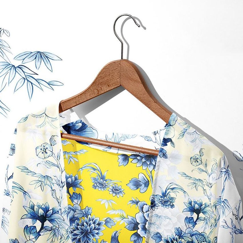 Chiffon kimono mockup on a wooden hanger, featuring a blue and white floral pattern with a bright yellow inner lining.