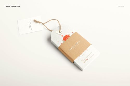 Paper label mockup featuring a rectangular tag with rounded edges, kraft paper band, and twine, shown on a light surface.