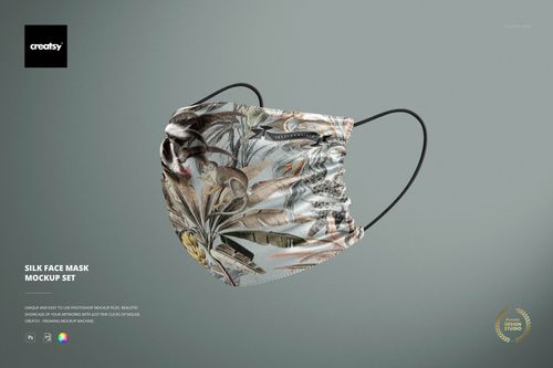 Silk face mask mockup featuring a detailed nature-inspired design, shown from the front against a plain backdrop.