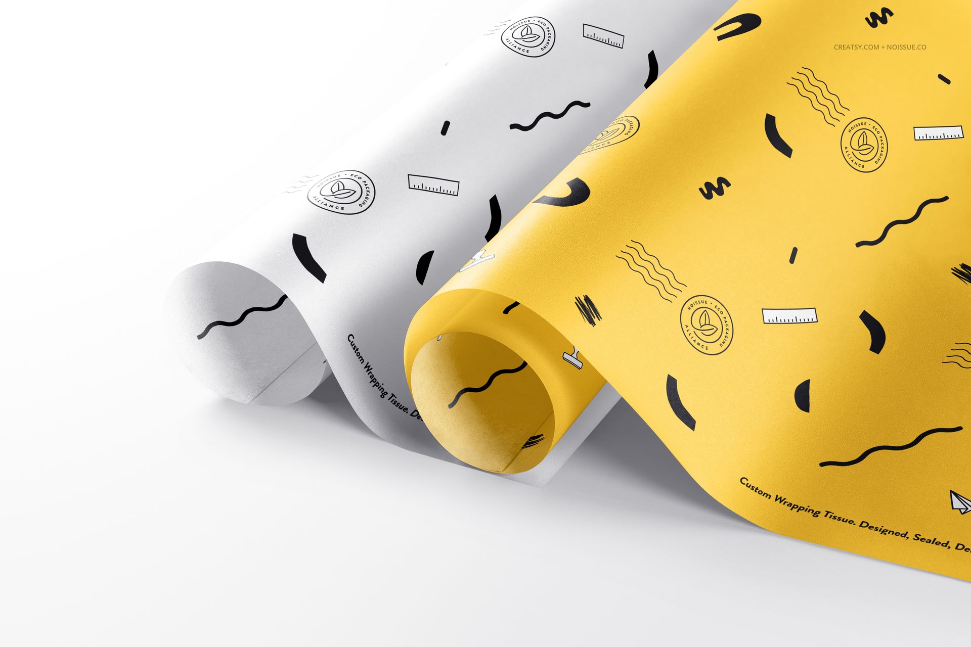 Rolled food safe paper mockup set featuring white and yellow sheets with playful abstract black designs, front perspective.