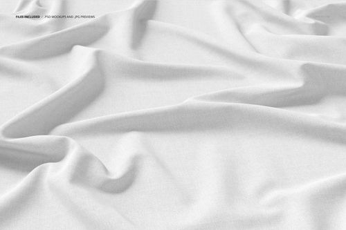 Close-up view of white cotton fabric mockup with soft folds and subtle texture, shown from above.