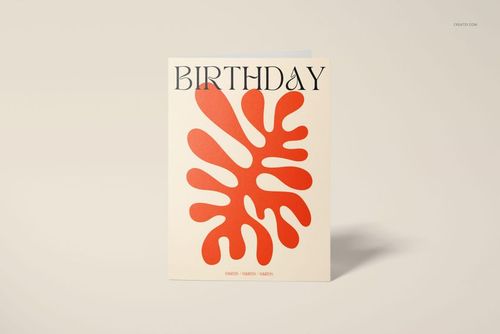 Front view of a 5x7 greeting card mockup standing upright on a light beige surface, featuring bold orange abstract shapes.