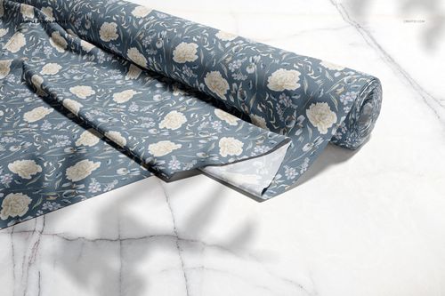 Blue floral patterned fabric roll and stack shown on a light marble background, fabric mockup perspective.