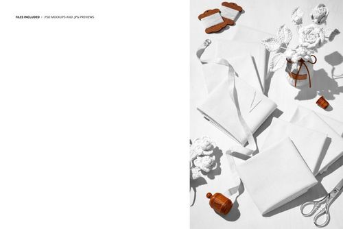 Folded cotton fabrics arranged on a white surface with crocheted flowers and wooden sewing props in a top view mockup.
