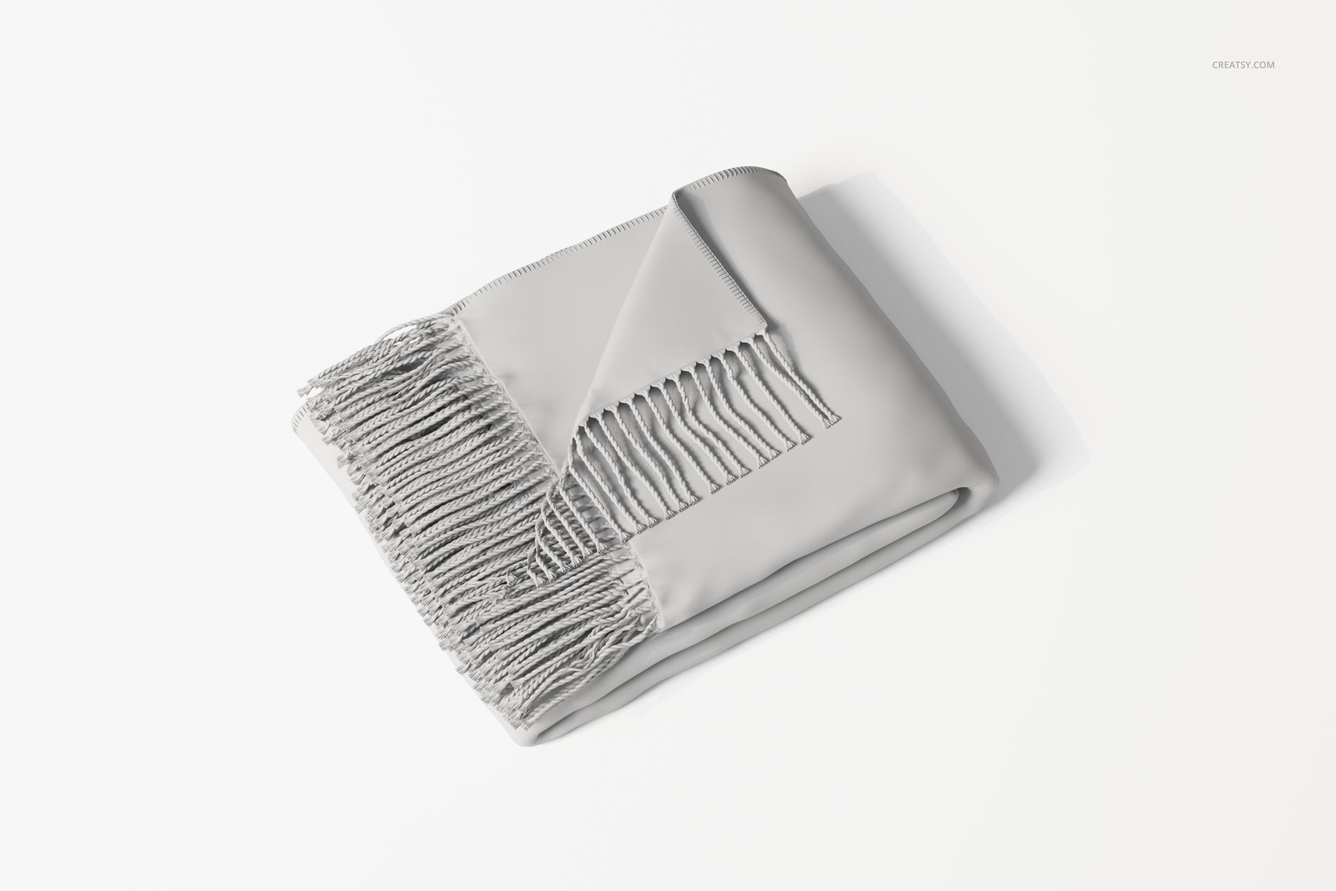 Folded fringe blanket in light gray color, shown from a top angle on a plain white background with visible corner wrap.