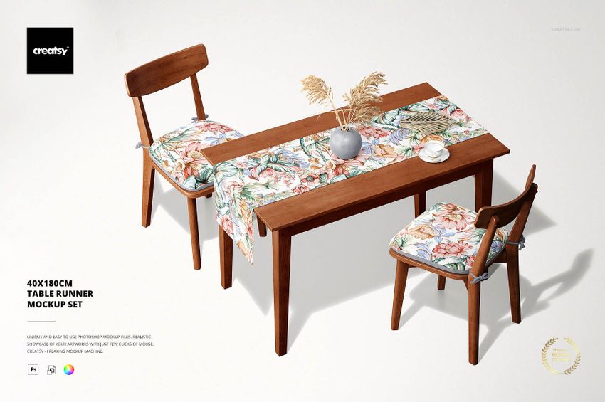Floral table runner mockup on a rectangular wooden table with two chairs, white background, overhead perspective.