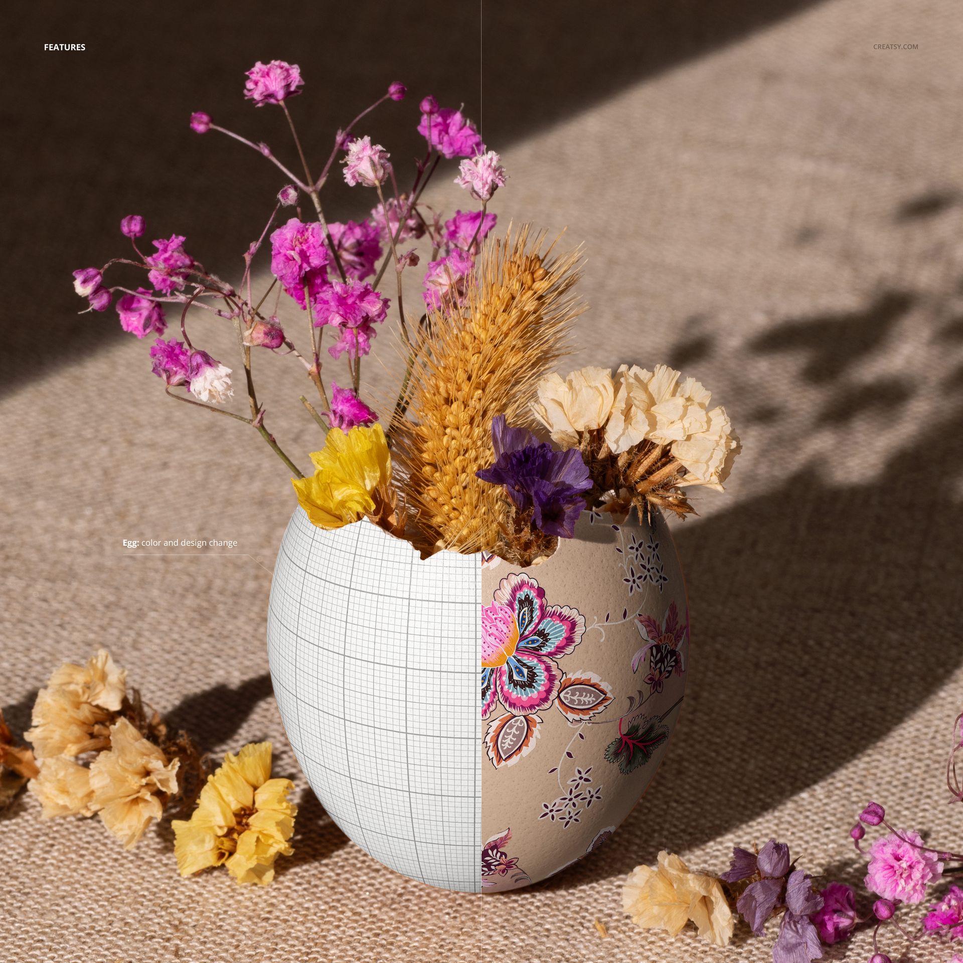 Painted Easter egg shell mockup featuring dried flowers and wheat, shown in a close-up on a textured fabric surface.