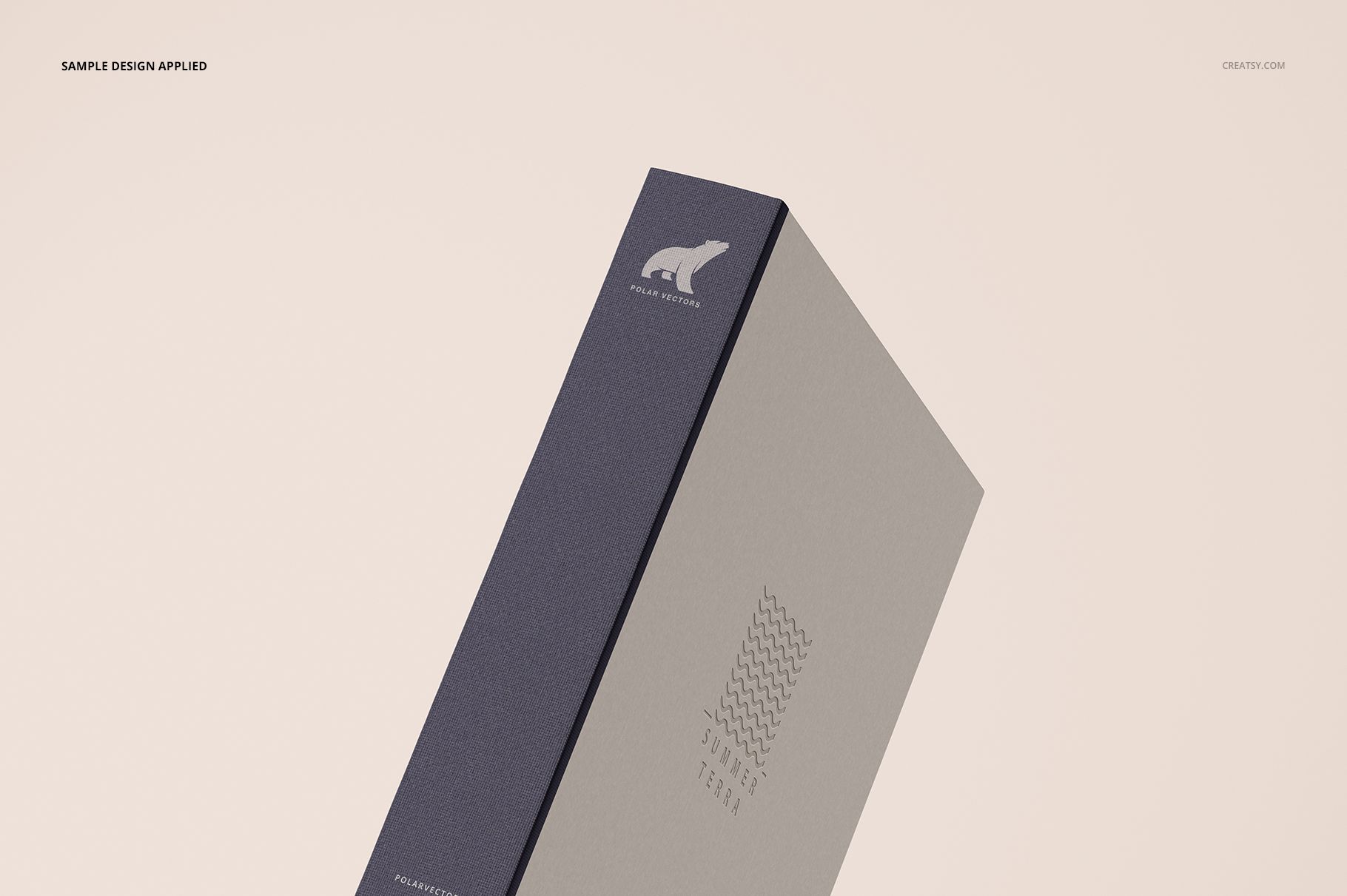 Hardcover artbook mockup with a gray cover and dark blue spine, shown from a side angle against a light background.