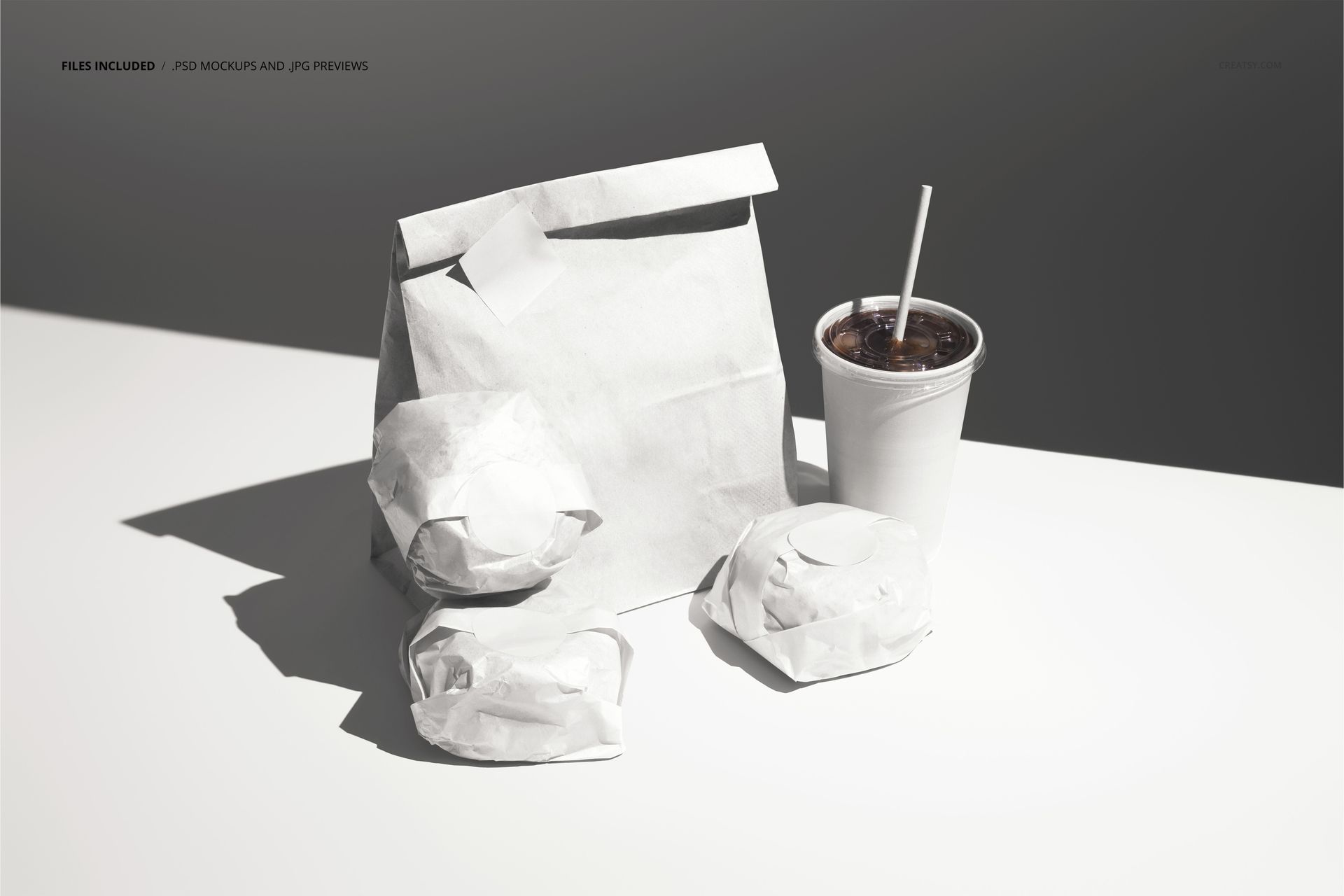 Front view of a PSD mockup displaying wrapped burgers, a paper bag, and a drink cup with straw in soft lighting.