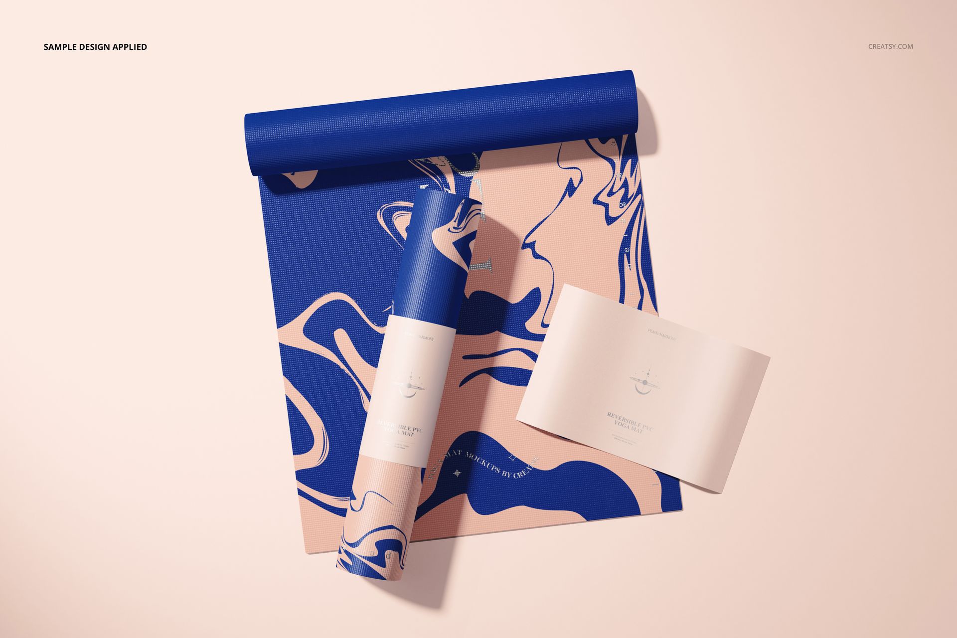 Top view of a yoga mat mockup featuring a blue and beige marbled design, with rolled and unrolled sections.