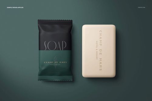 Front view of hotel hand soap mockup set with a rectangular bar and a dark green wrapped packet on a green background.