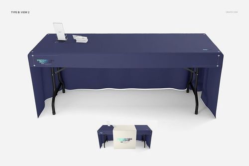 PSD mockup featuring a long table draped in a plain blue cloth, viewed from the front with a white runner and accessories.