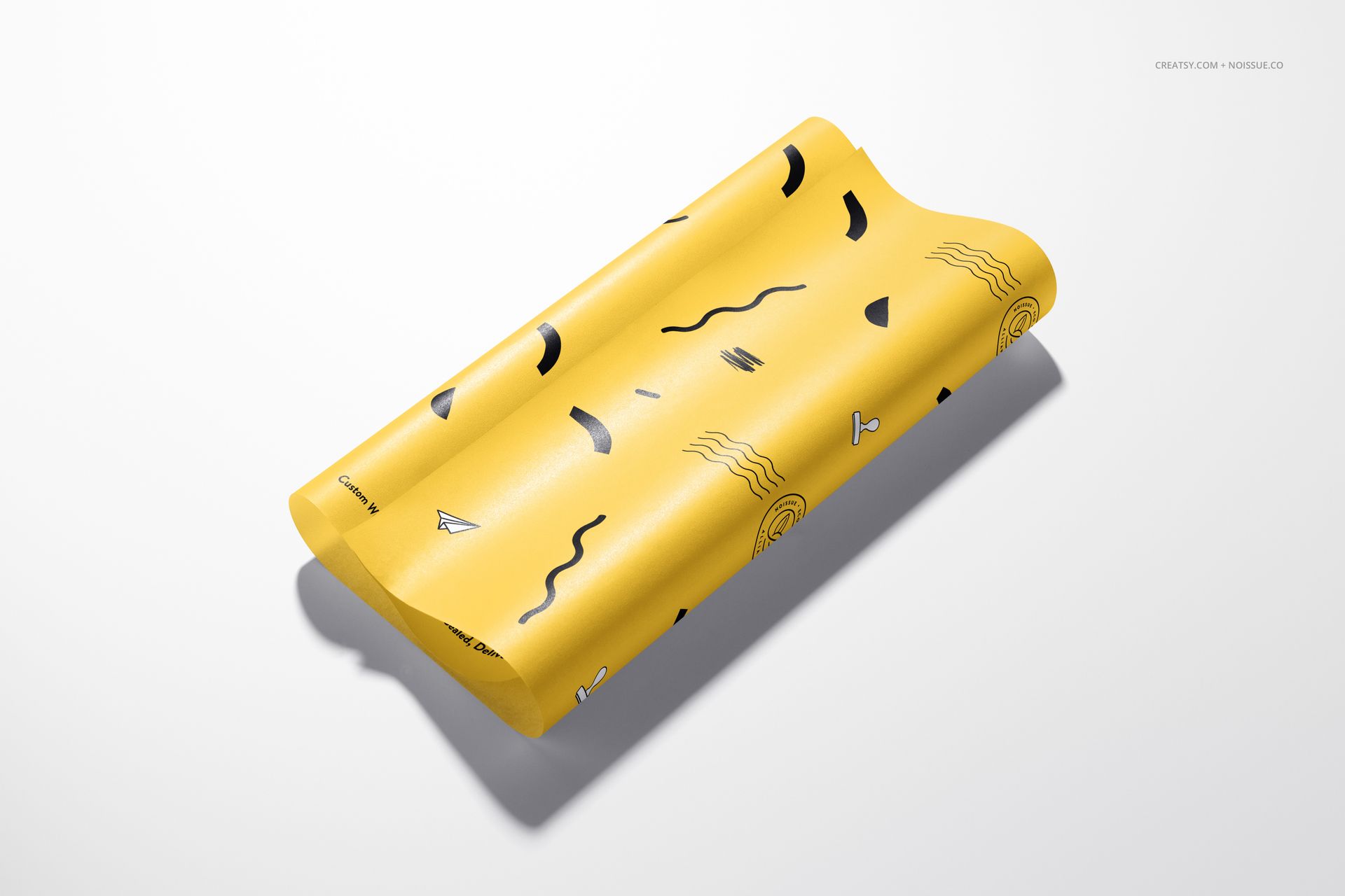 PSD mockup of food safe wrapping paper in yellow with assorted abstract designs, presented on a plain background.