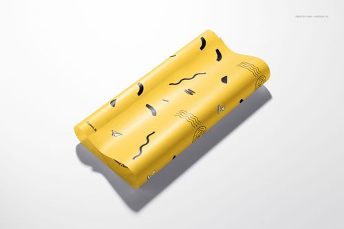PSD mockup of food safe wrapping paper in yellow with assorted abstract designs, presented on a plain background.