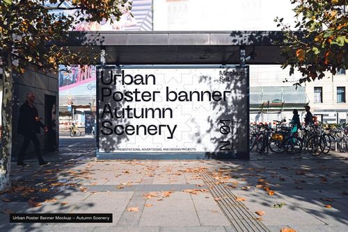 Large outdoor poster banner mockup displayed on a city street, surrounded by autumn trees and bicycles.