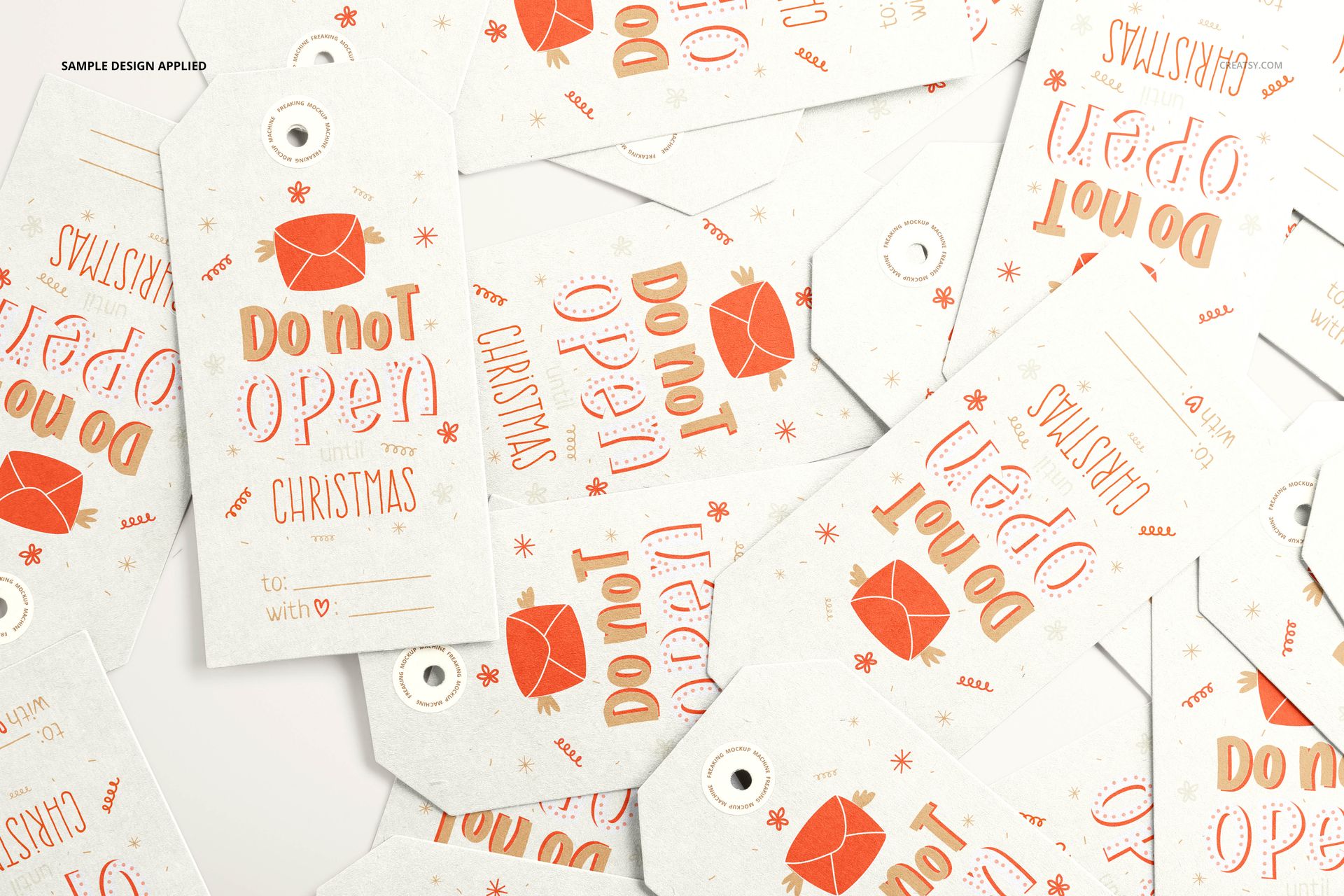PSD mockup showing assorted paper gift tags with printed holiday graphics and messages, arranged in a random layout.