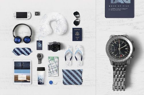 Travel identity PSD mockup featuring electronics, eyewear, footwear, and personal items displayed from a top view.