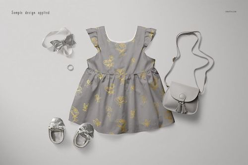 Front view of a gray baby dress mockup with gold floral accents, styled with silver shoes, headband, and purse.