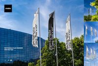 Rectangle flag banner PSD mockup showing vertical flags in black and white, positioned outdoors with blue sky and trees.