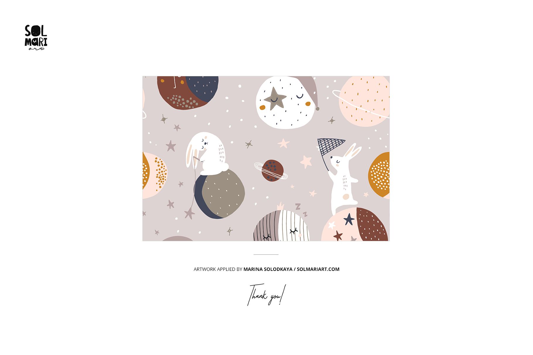 Hooded baby towel mockup featuring a playful space-themed pattern with rabbits, stars, and planets on a soft background.
