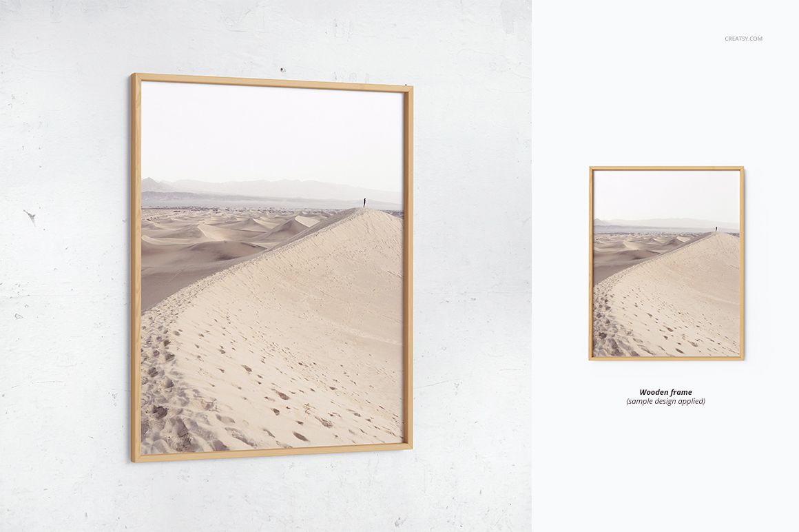 Front view of a thin wooden frame mockup displaying a desert landscape print on a light wall background.