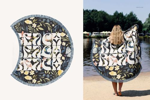 PSD mockup of a circular fringed beach towel with colorful floral and swan design, viewed from above and at a lakeshore.