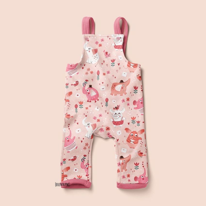 Kids fleece dungarees mockup featuring a pink overall with playful animal and floral patterns on a light background.