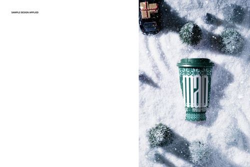 Winter-themed PSD mockup featuring a green paper coffee cup with lid, snow, small trees, and a toy car from top view.