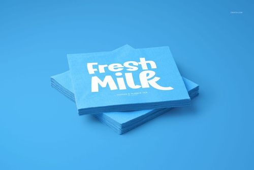 Blue napkin mockup set featuring square napkins with white lettering, viewed from a slightly elevated angle.