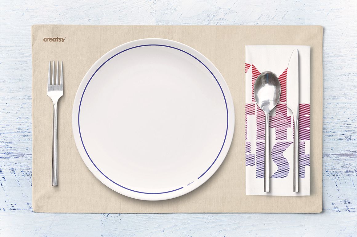 Seafood restaurant mockup featuring a round white plate, silverware, and folded napkin on a neutral placemat.